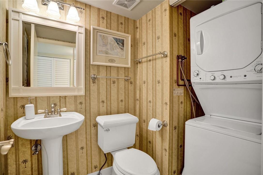 The half bathroom houses the washing machine and dryer, which is concealed behind a folding door.
