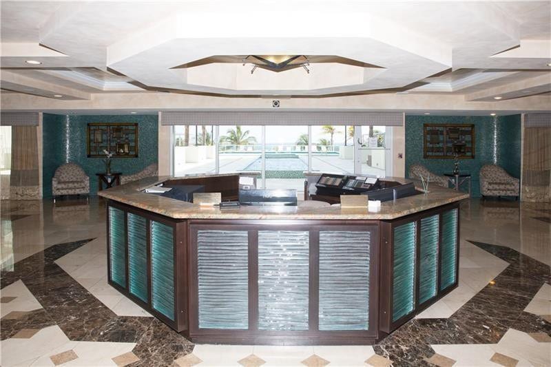 Security desk at entrance: Southpoint has 24/7 security. The two luxury high rise towers are connected by this lovely lobby. A view out to the beautiful pool deck is visible.