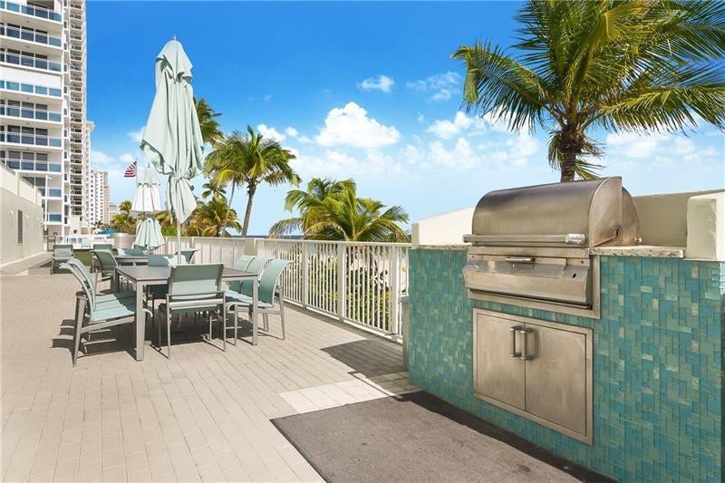 The lower deck has lots of seating, 2 bbq grills, the bocce court and stairs leading up to the tennis court.