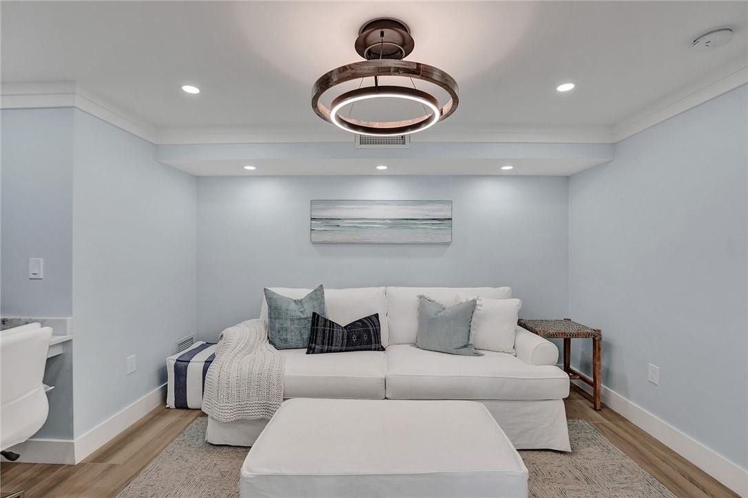 The bonus room is perfect for a dining room, a 3rd bedroom, a den or an office. There is a closet to the wall to right of the couch.