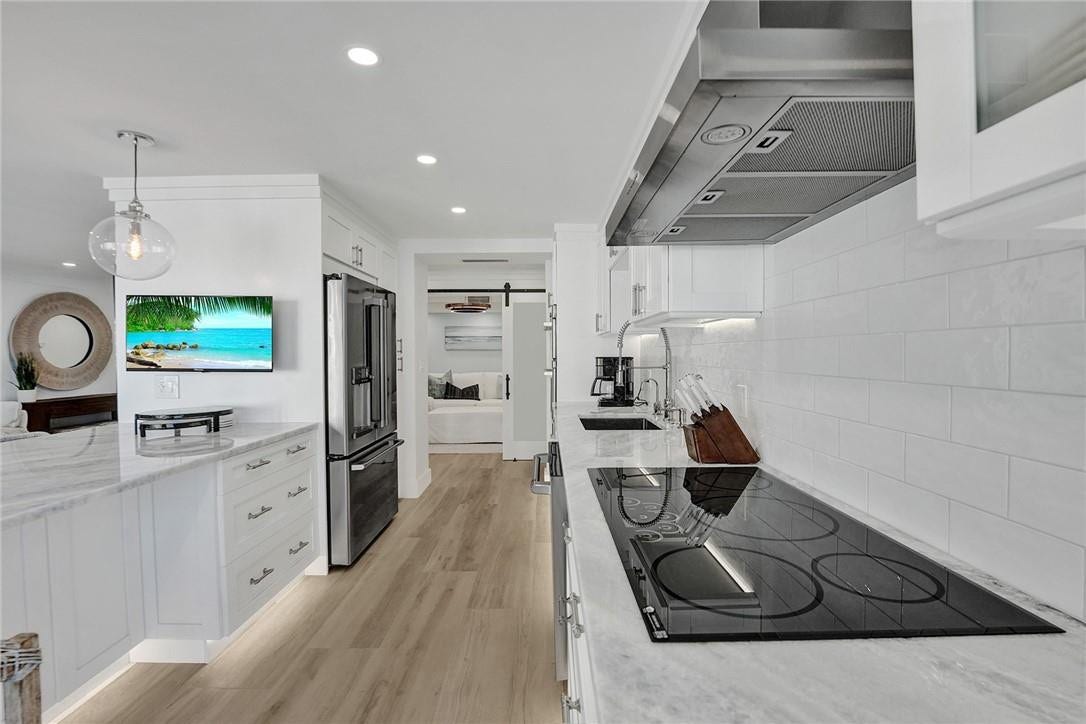 Note the cabinets under the quartzite eat in countertop on the left: extra cabinet storage.From this view, you can see the bonus room, which can be used as a dining room, a 3rd bedroom, an office or a den.