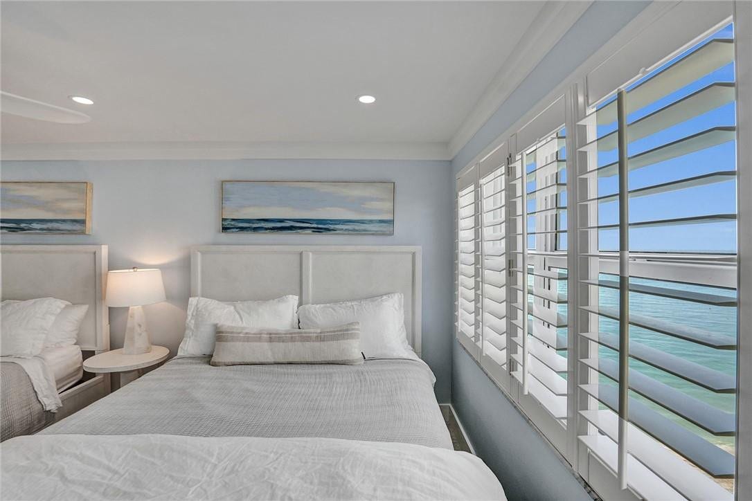 The second bedroom features recessed lighting and plantation shutters.