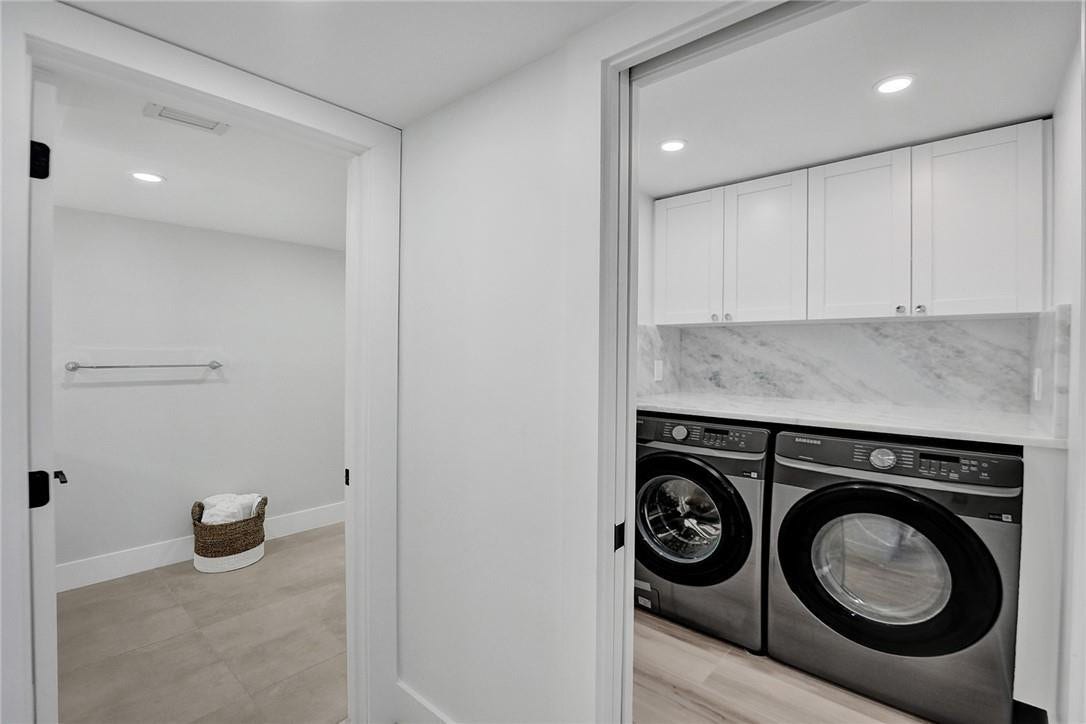 The second bathroom is to the left of the laundry room.