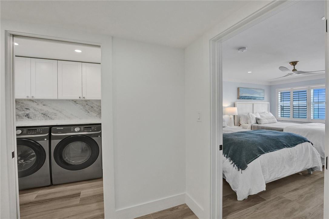 As you walk towards the second bedroom, a laundry room area was built. It features a full size Samsung washer and dryer, lots of storage and the new fuse box is here out of sight. To the right of the laundry room is the second bedroom, and to the left of the laundry room is the second bathroom.