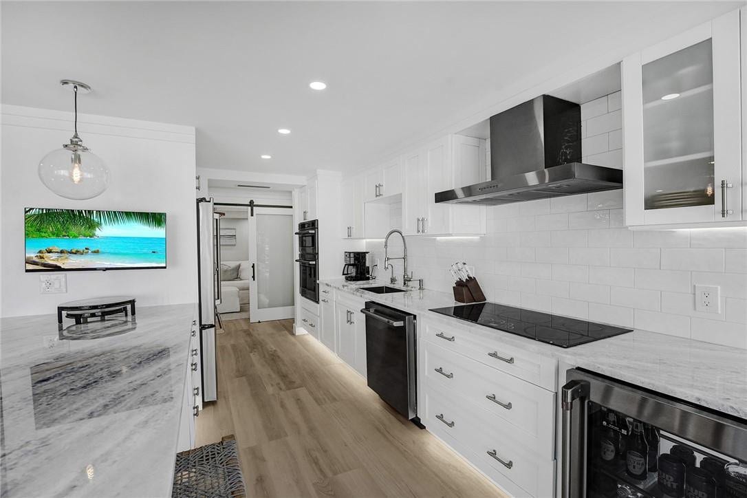 The owners installed under the counter lighting and the toe kick lighting under the bottom kitchen cabinets. All of the draws and pullouts are easy close. The glass door leads into the bonus room, which can be used as a dining room, 3rd bedroom, office or a den.