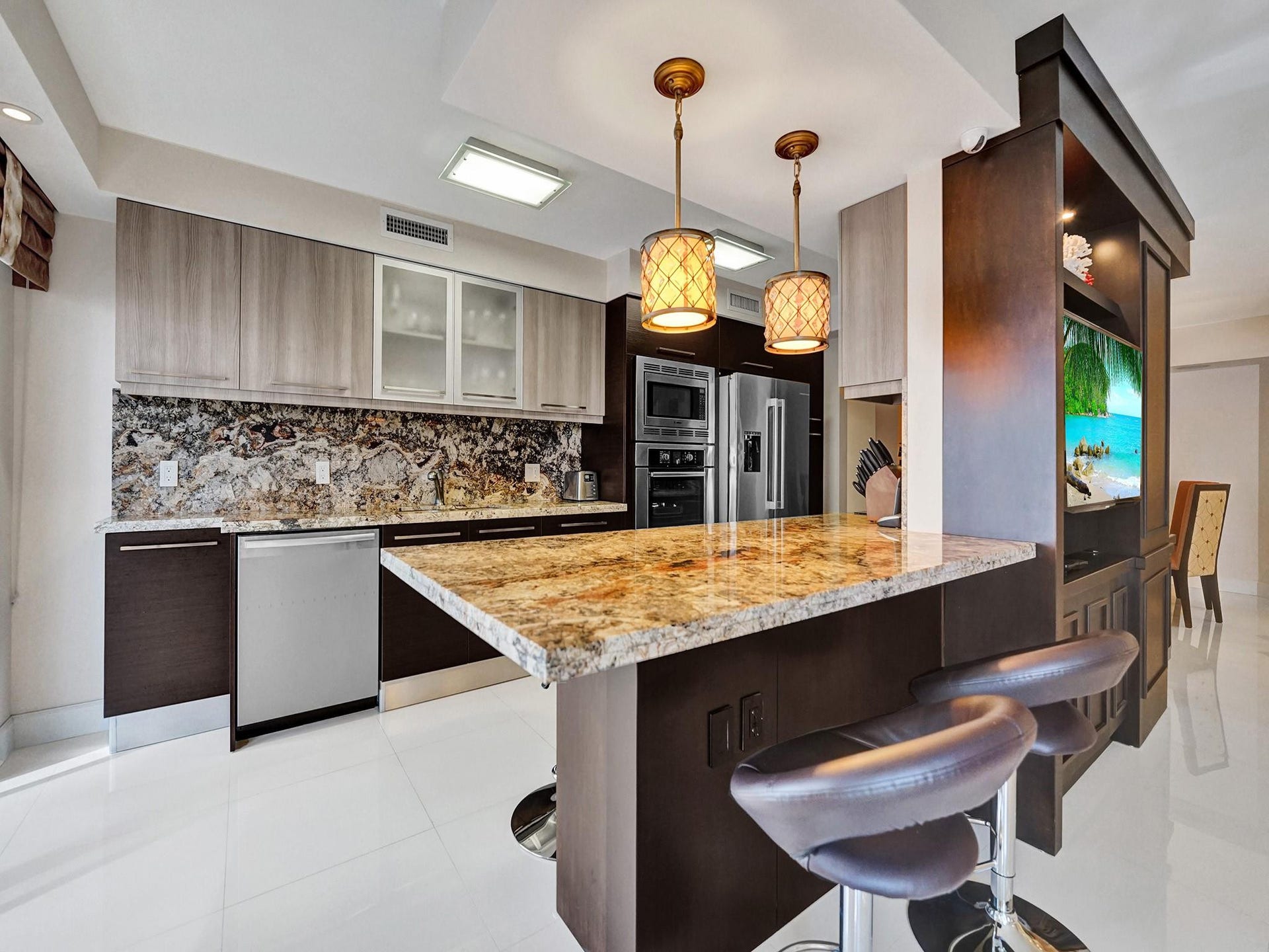 Custom Italian cabinetry, gorgeous granite countertops and backsplash and stainless Bosch appliances are high end features of this lovely kitchen.