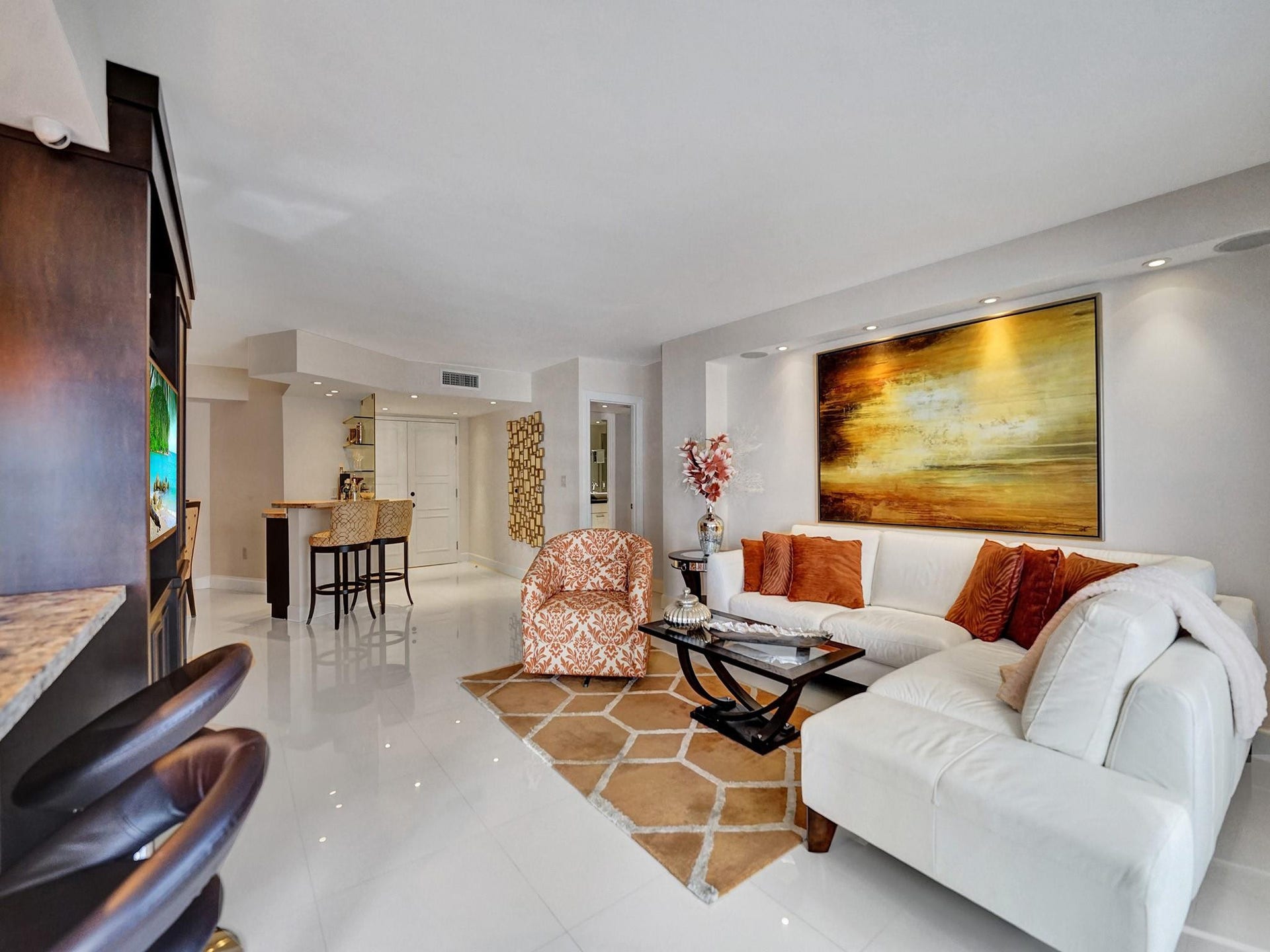 The double door apartment entry is to the right of the bar area chairs.