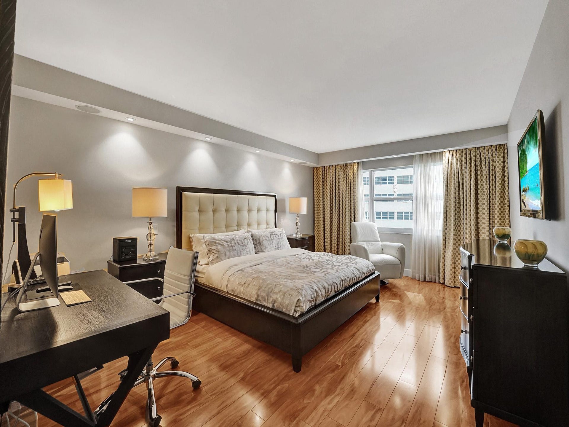 What a beautiful and elegant primary bedroom. An engineered wood flooring gives this room a rich and luxurious feeling.