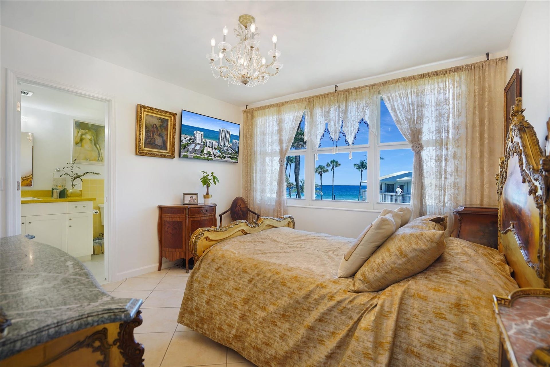 1530 S Ocean Boulevard, #203, Lauderdale By The Sea, FL 33062 The primary bedroom has lovely ocean views. The primary bedroom chandelier will stay.