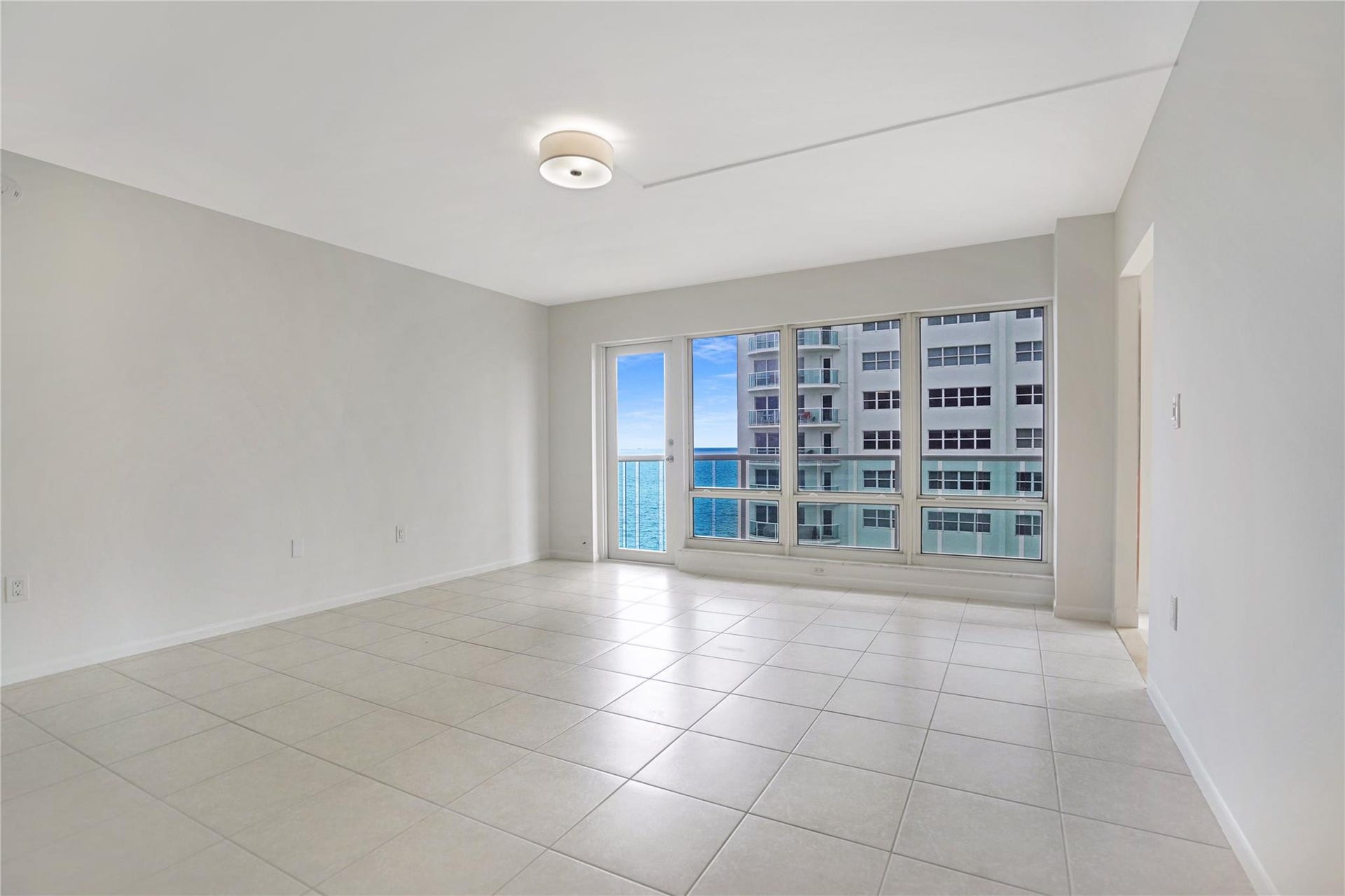 This apartment is on the 11th floor. The door to the left of the windows leads out to the balcony.