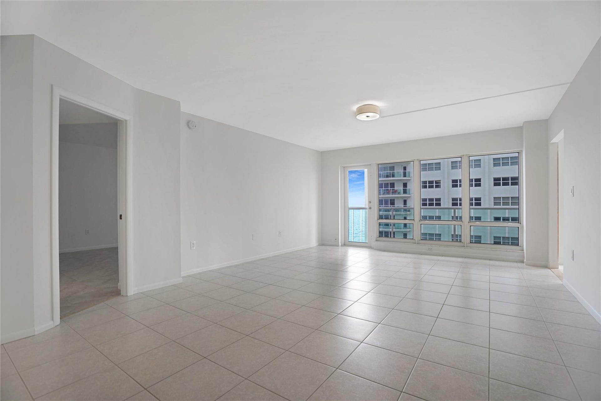 This is a split bedroom layout: The bedrooms are on each side of the apartment. The doorway to the left leads into the primary bedroom.