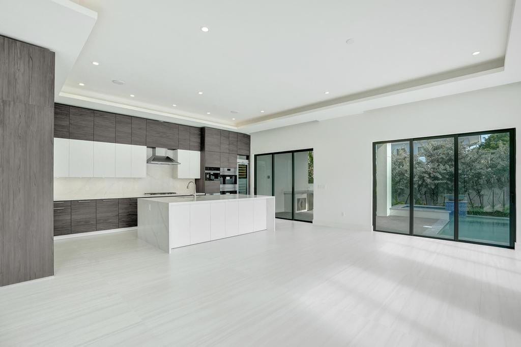 Open-Concept Kitchen Flowing into Dining and Living Areas.