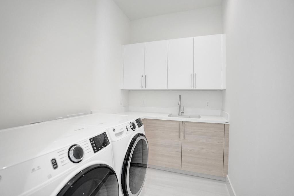 Laundry Room  First-Floor Laundry with Custom Cabinetry, Laundry Sink, and Upgraded Washer and Dryer