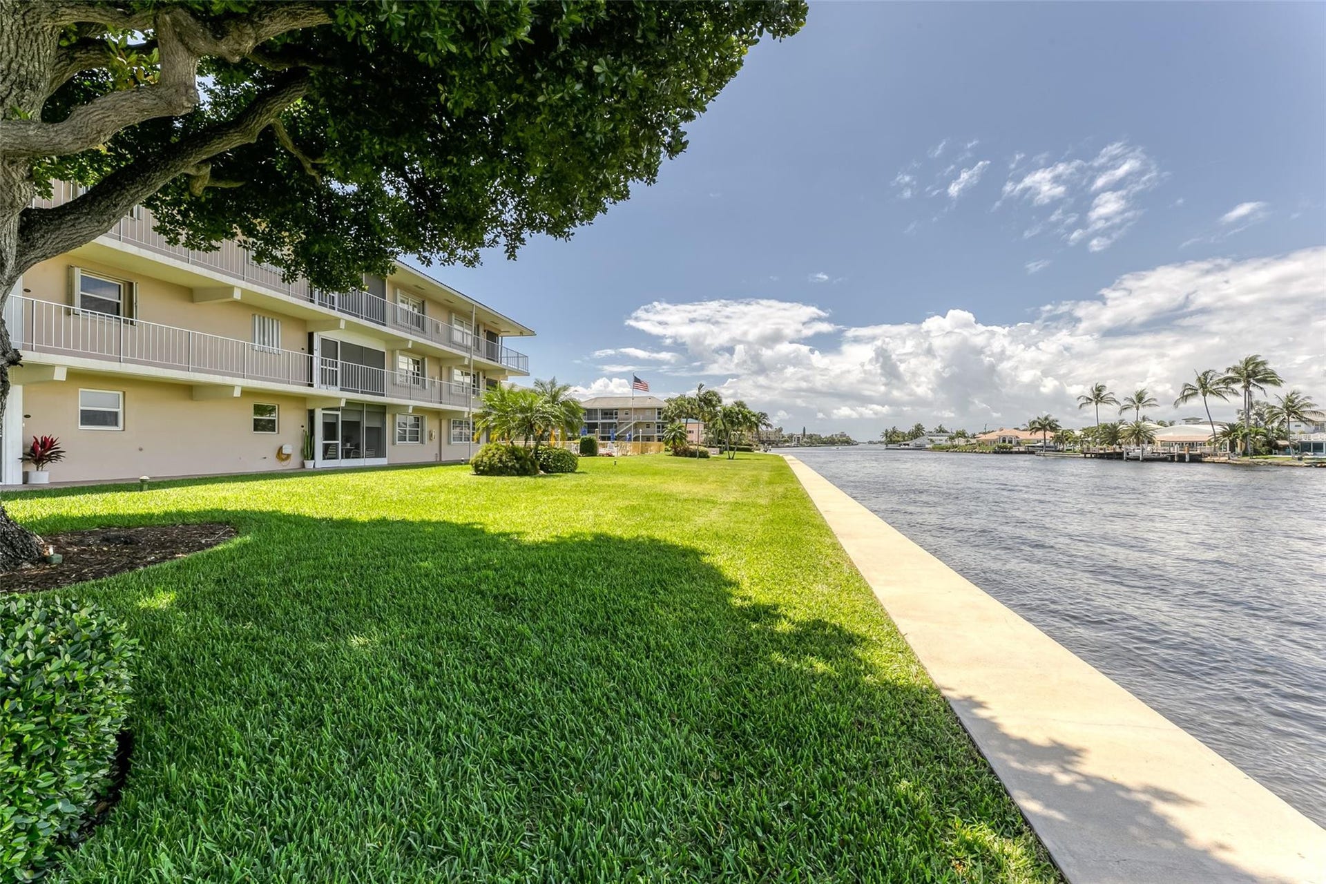 Great green space located along the water with meticulous landscaping and mature trees