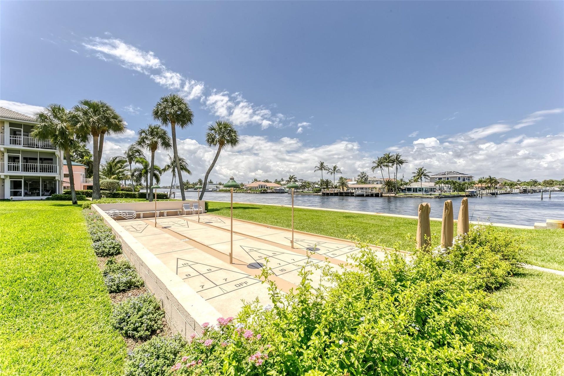 Shuffleboard located with amazing views and tons of green space and tropical landscaping