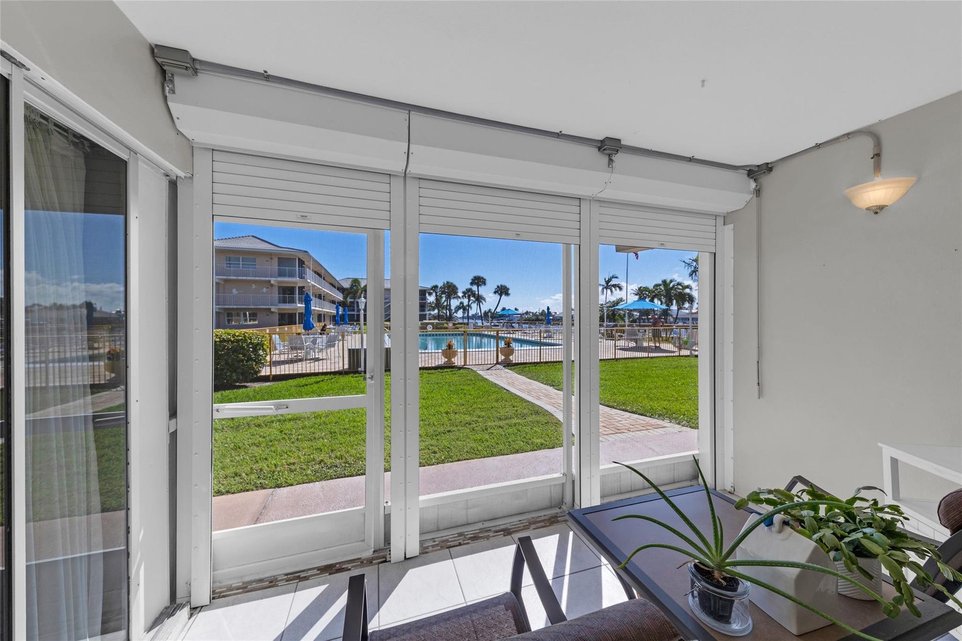 Gorgeous views offered from screened patio overlooking pool and water