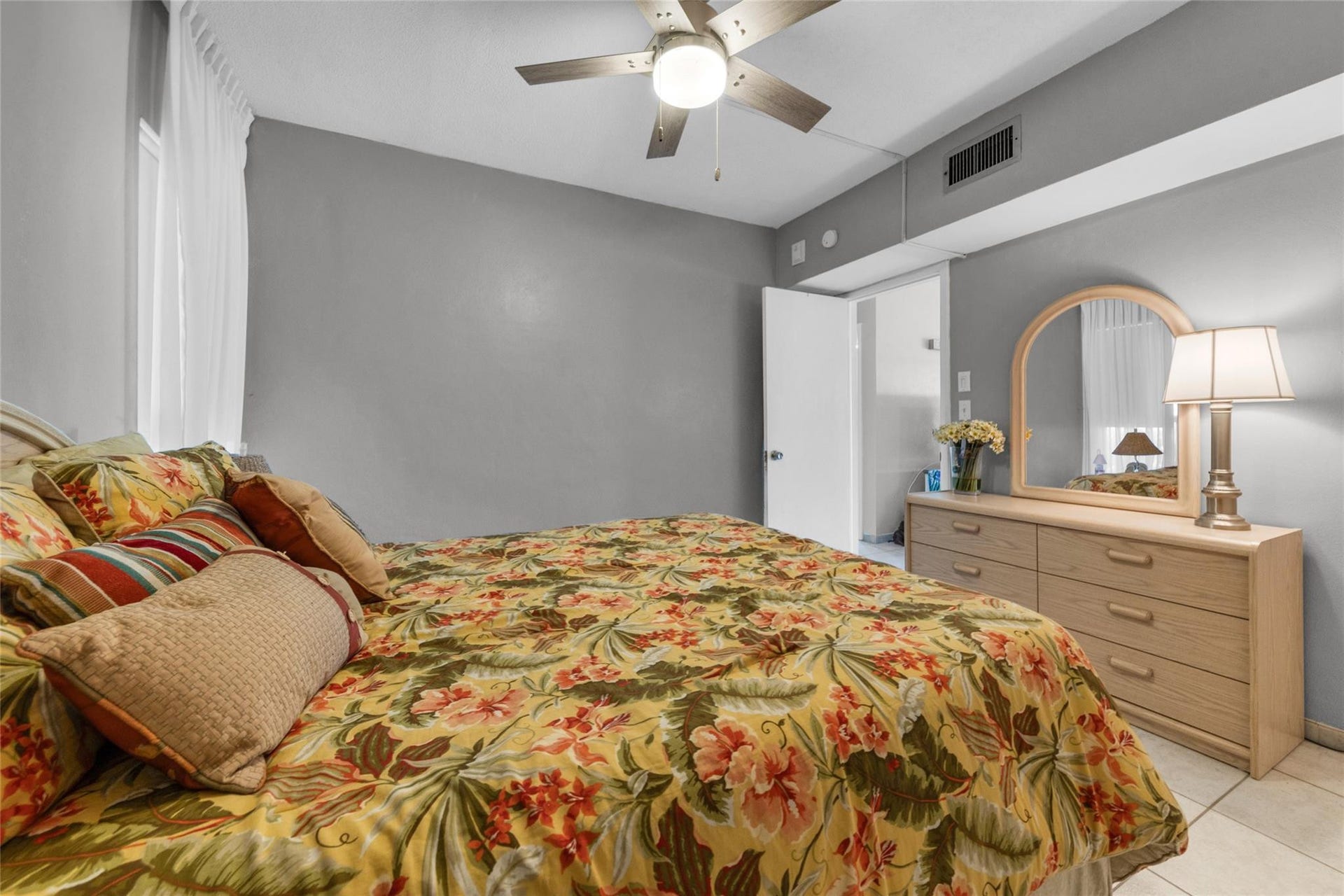 Second bedroom offers tile flooring and overhead ceiling fan