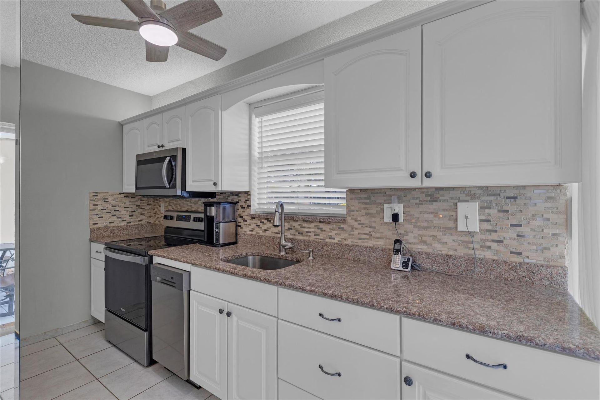 Kitchen offers white cabinets and stainless steel appliances