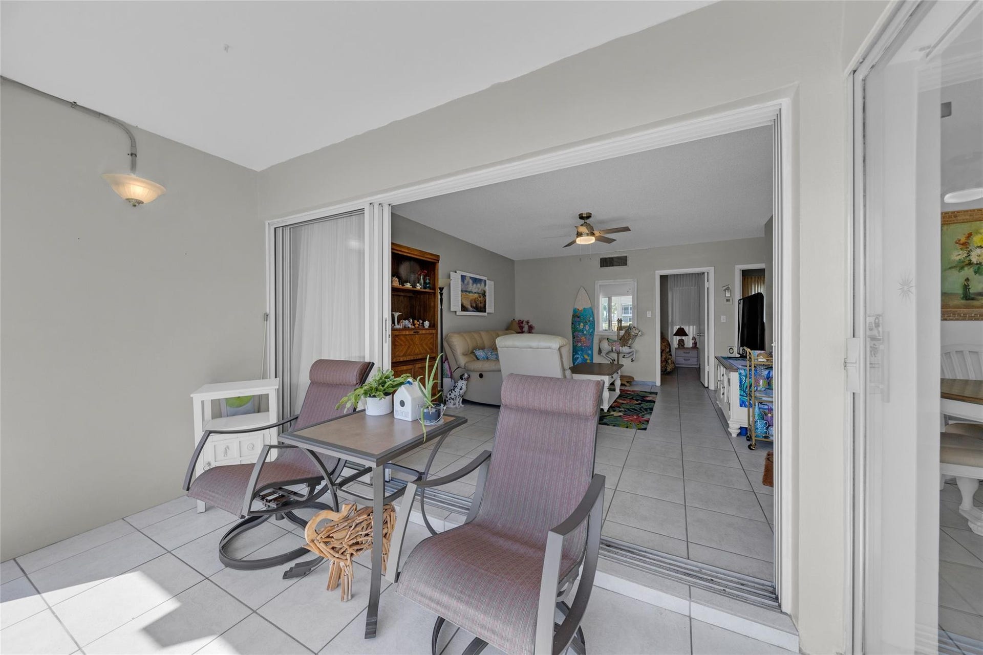 screened patio offers sliders into living room