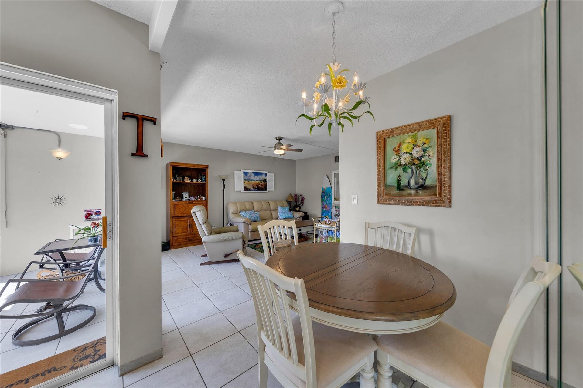 Dining room sits in between kitchen and living room with a slider to front screened patio