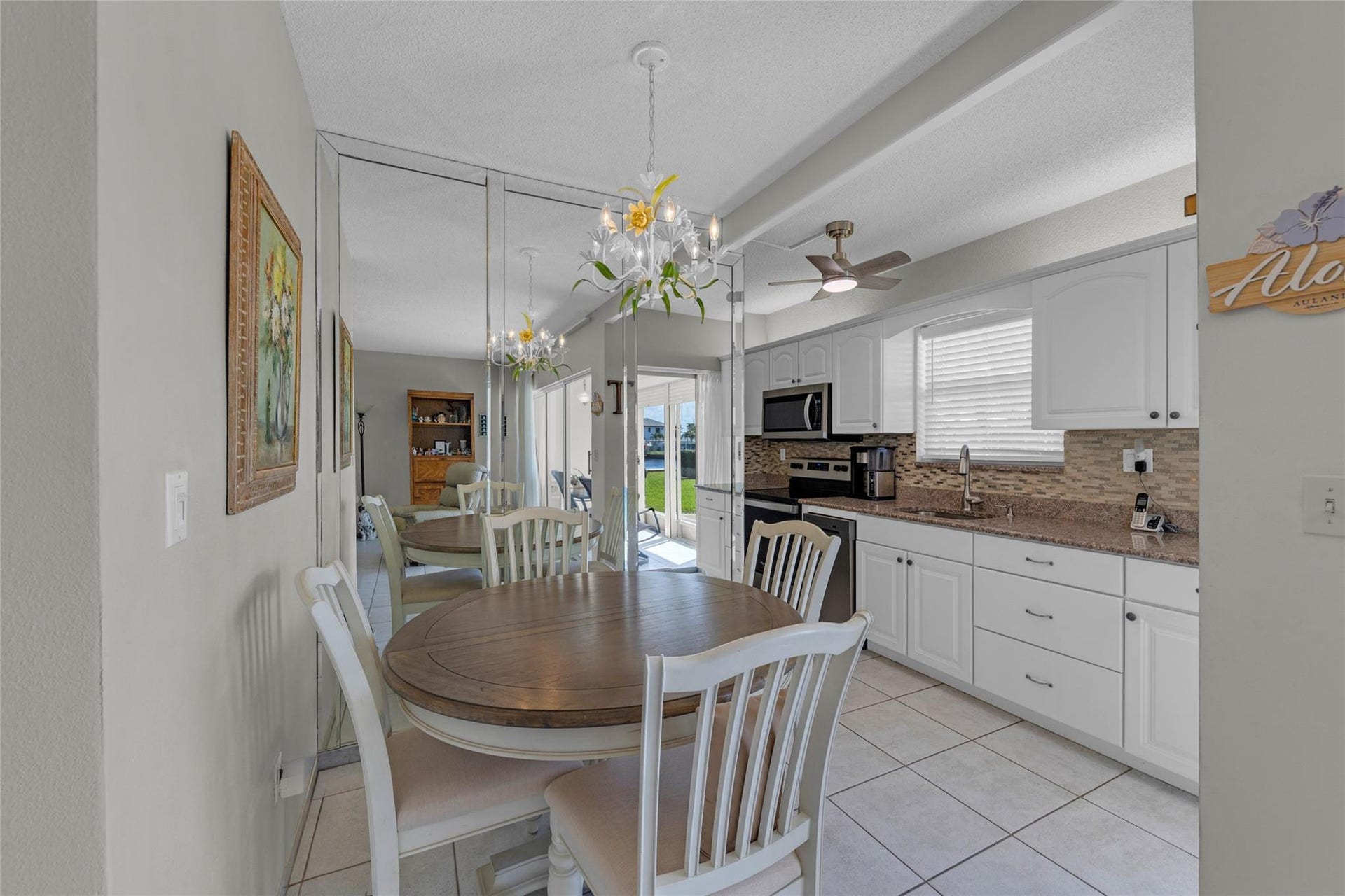 Dining and kitchen with tile flooring and an abundance of natural light