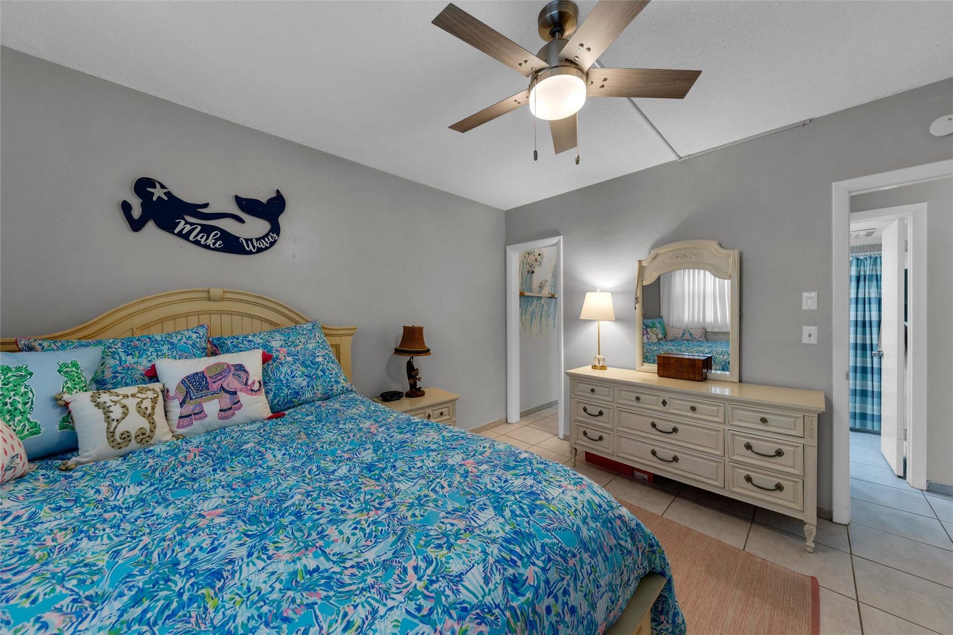 Master bedroom with ensuite bathroom and overhead fan