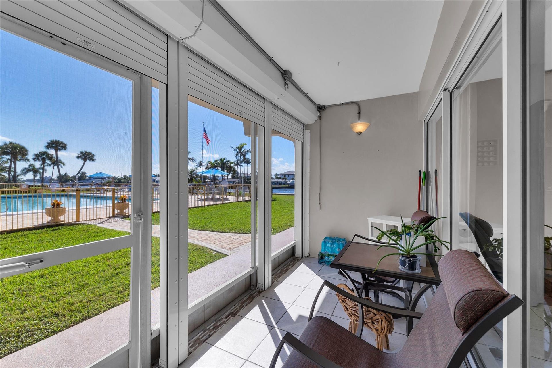 Enjoy sitting on your gorgeous screen porch and enjoy the views of the intracoastal and pool area, porch offers tile flooring and storm roll down shutters.