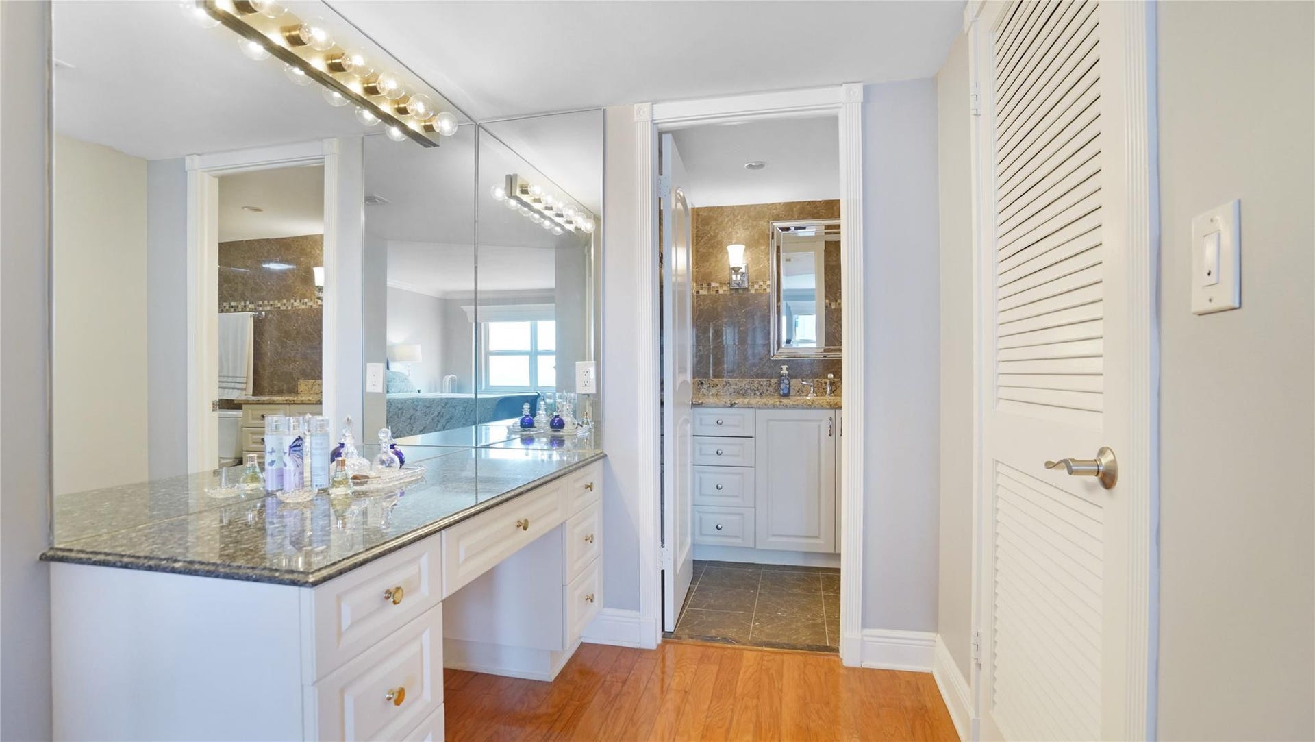 A beautiful vanity area leads from the primary bedroom to the primary bathroom.