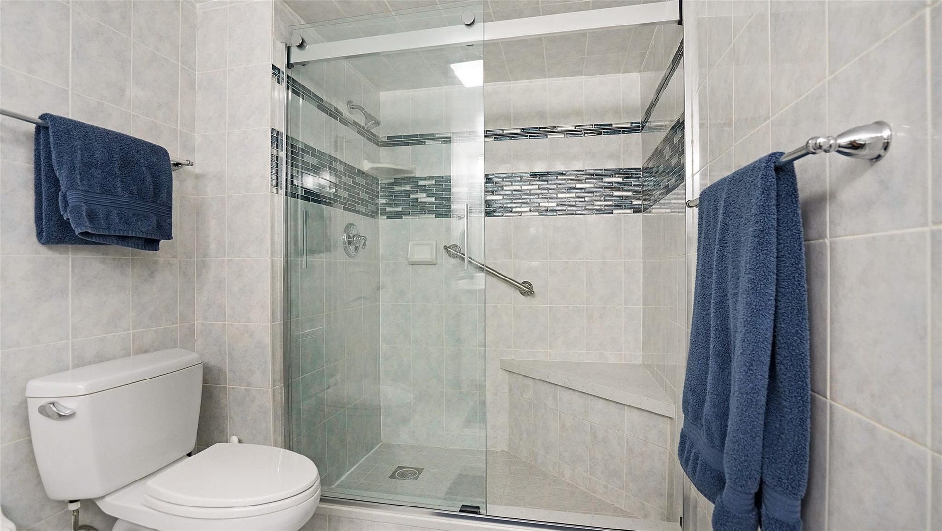 The second bathroom has an oversized shower area.