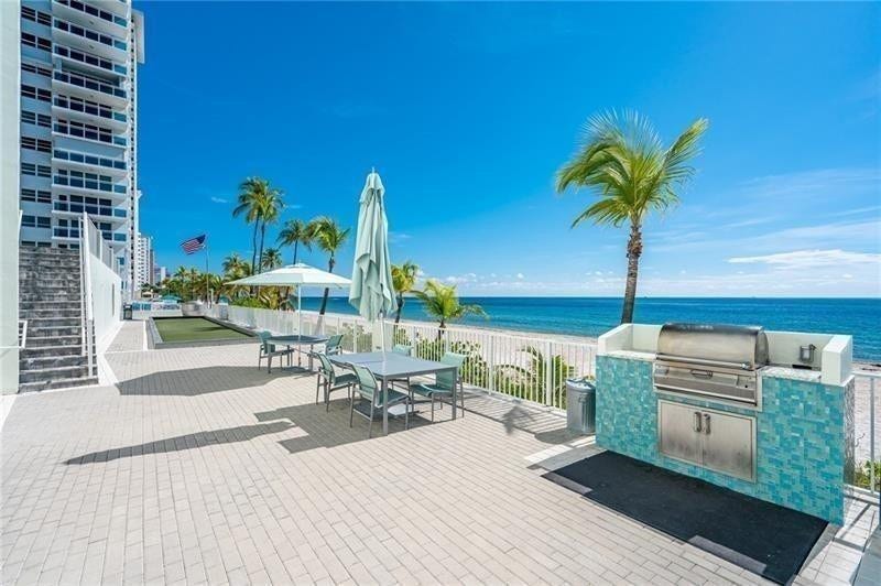 Our lower deck has several barbeque options. The bocce court is here. The stairs on the left lead up to the tennis court.You are only a few steps to the beach.