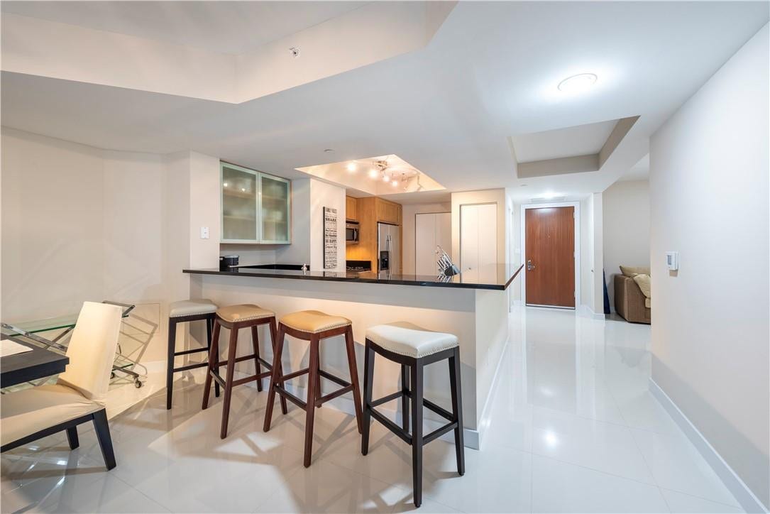 Front entry in the rear, bar top and den to the right