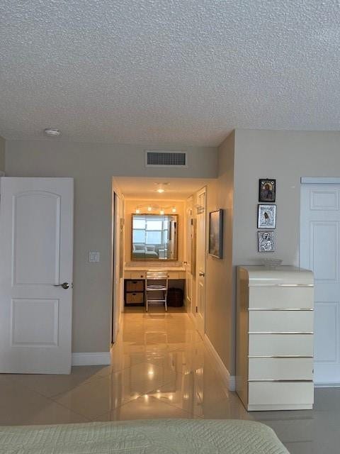 There are two walk in closets to the right of the mirror. There is another closet on the left. The 4th closet is to the right of the tall bureau.