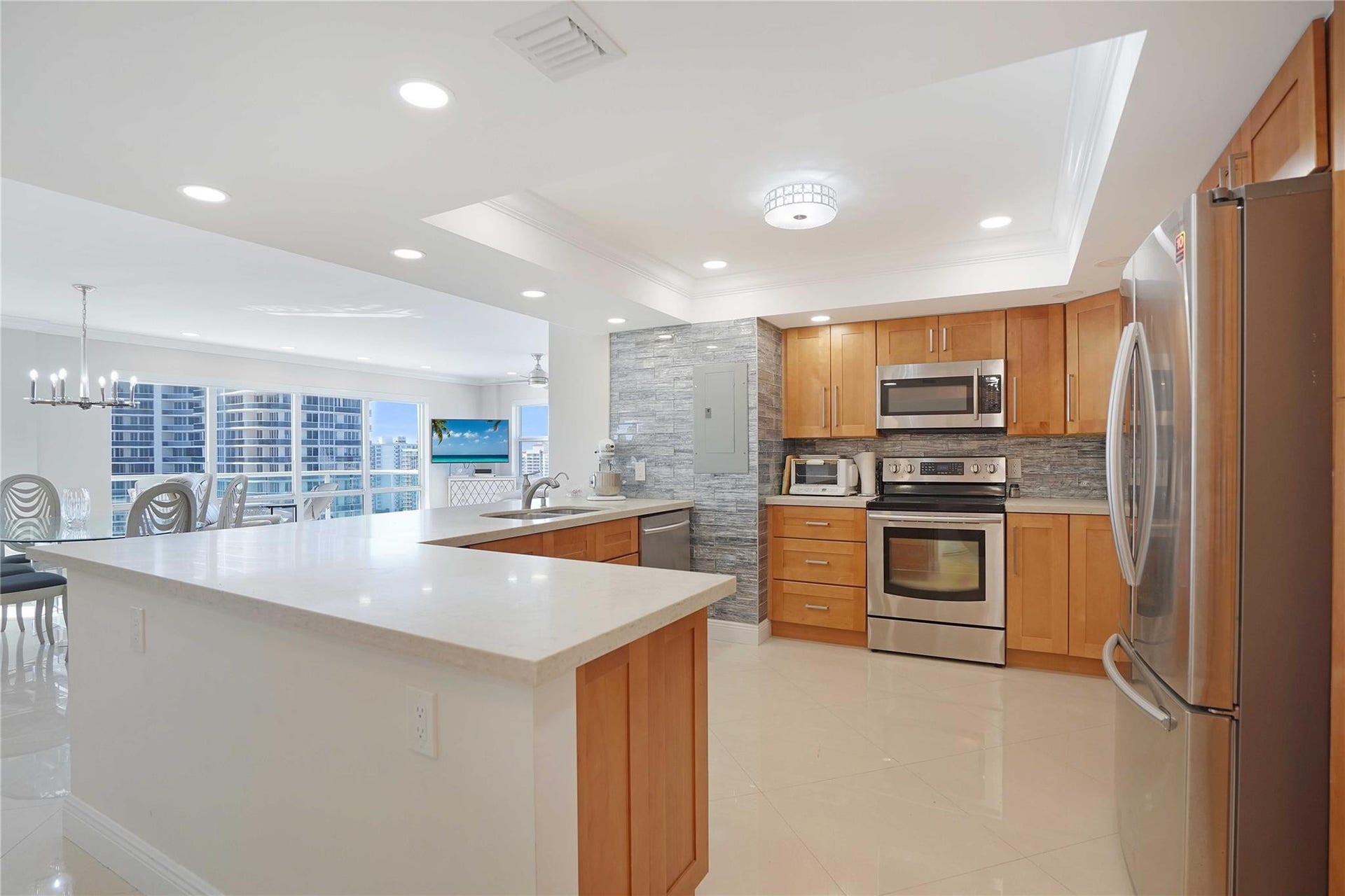 The remodeled kitchen was opened up, ensuring an open, bright and airy feeling as well as custom cabinets, quartz countertops and Samsung stainless appliances.