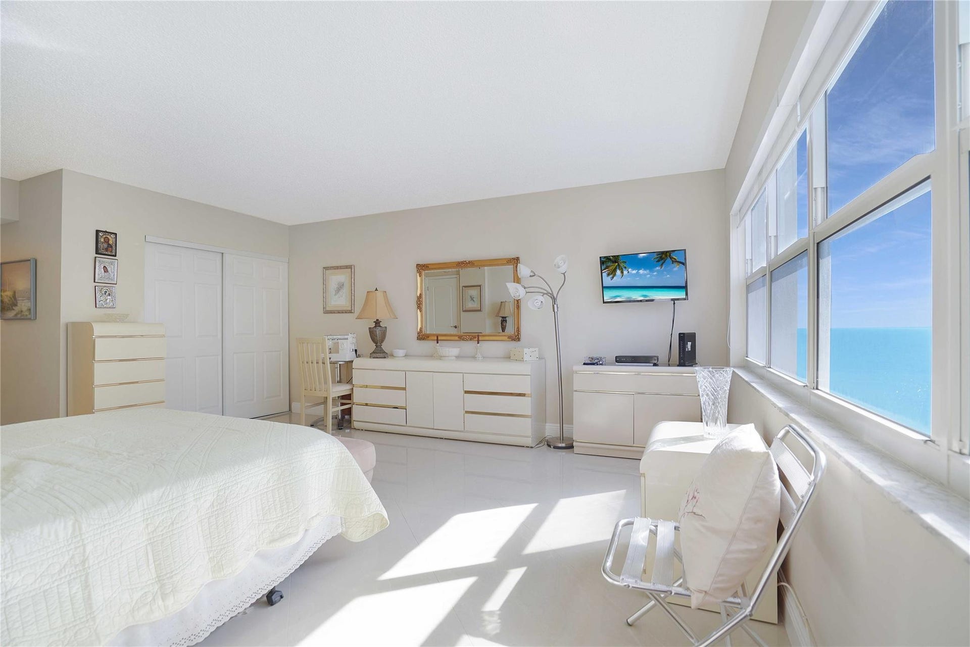 Look at the ocean views from your bed in this primary bedroom.