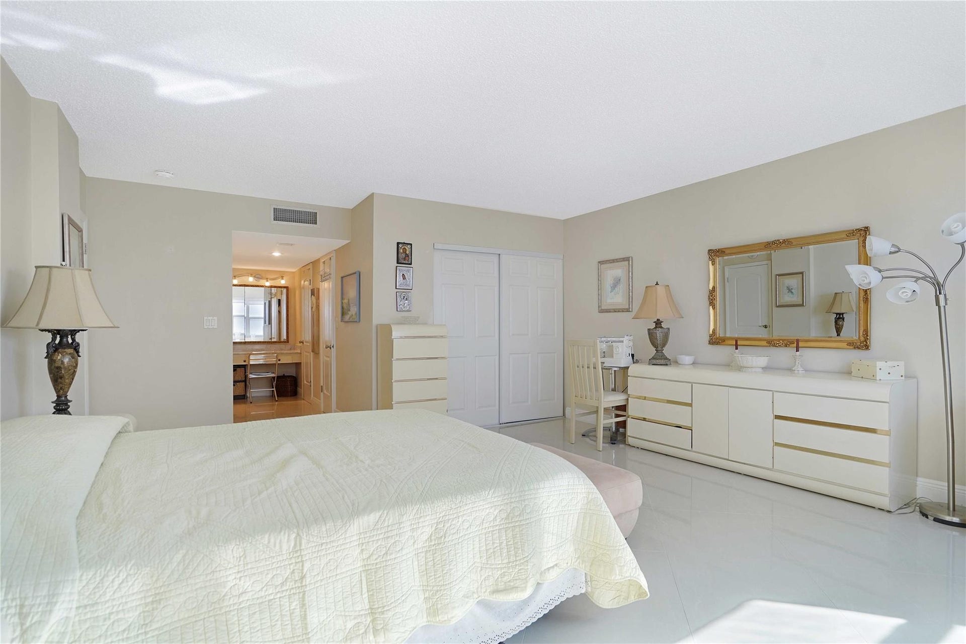 There are 4 closets in this bedroom: two are walk ins. The lit area leads into the primary bathroom.