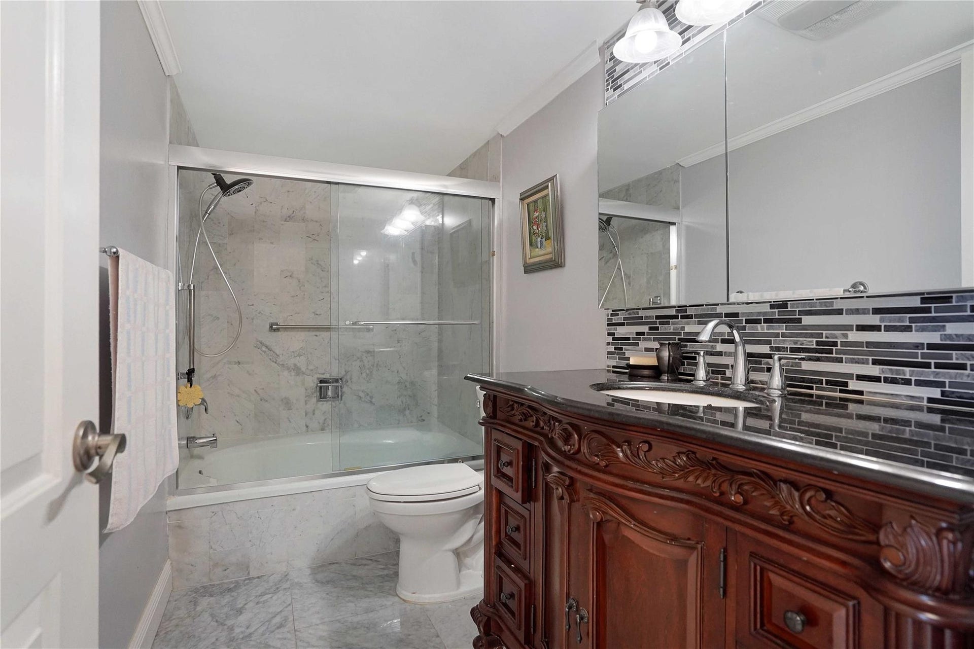 The primary bathroom has marble floors.