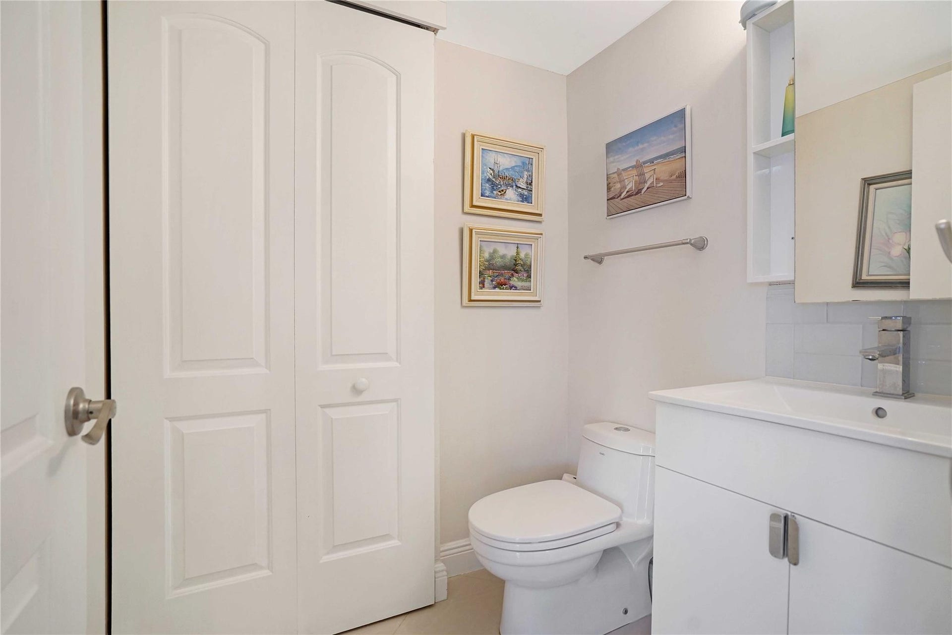 The half bathroom houses the washer and dryer behind the door.