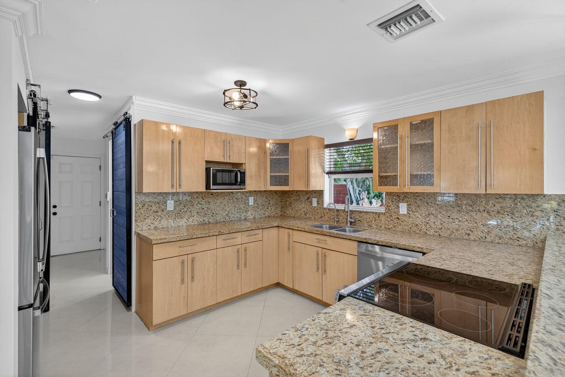 Off the Kitchen there is a full bath, utility/laundry room, and a 2 car garage.