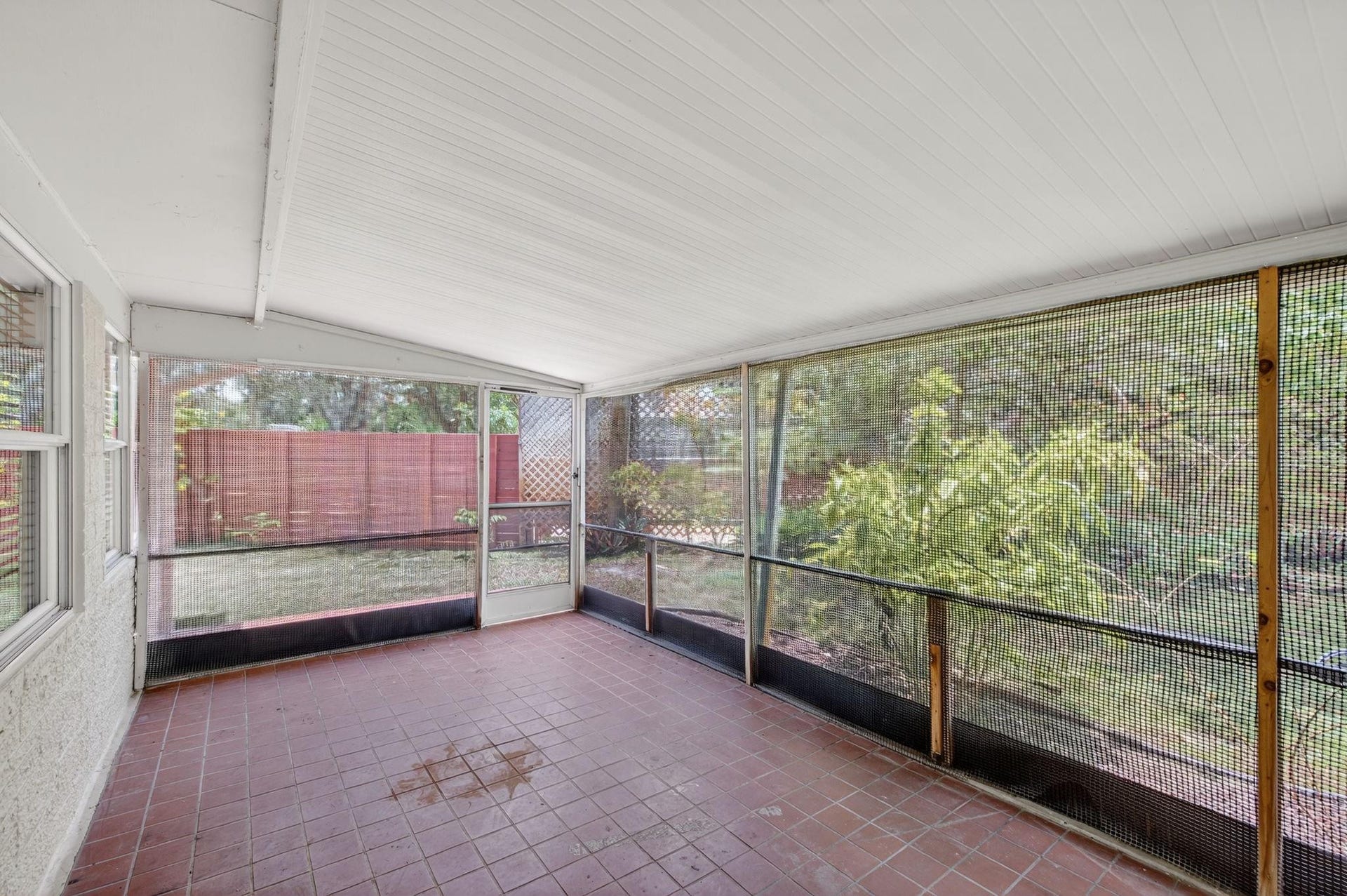 Screened-In Patio with access to private and lush backyard.