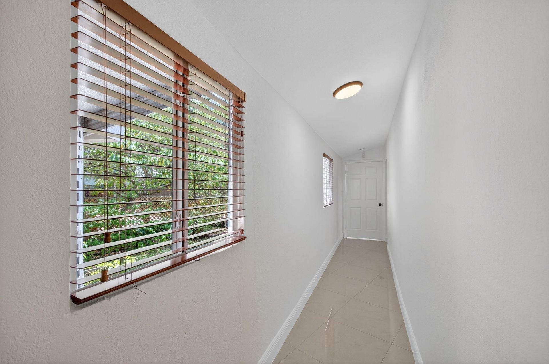 Hallway to bedrooms and large storage closet.