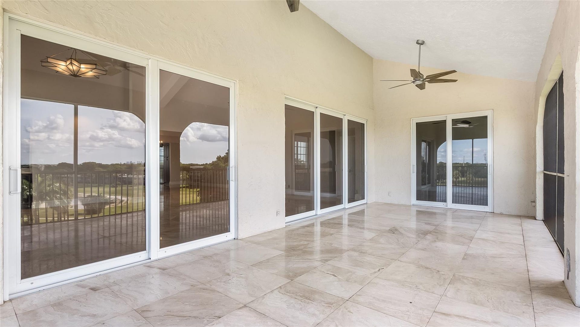4116 W Palm Aire Drive, #166b, Pompano Beach, FL 33069 Multiple sliding glass doors create seamless flow between indoor and outdoor living areas.