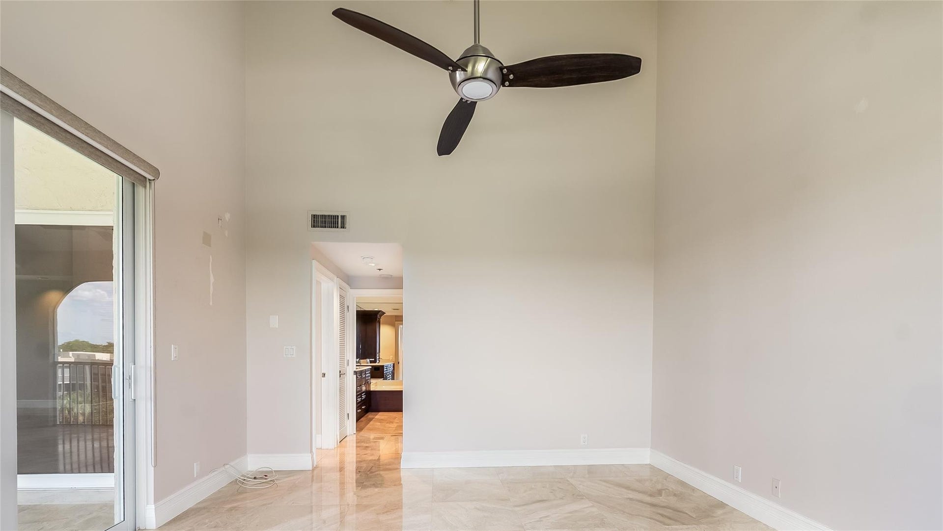 4116 W Palm Aire Drive, #166b, Pompano Beach, FL 33069 Primary Bed: Vaulted ceilings, tile floors, and sliding glass doors provide a peaceful connection to the balcony and en suite bath.