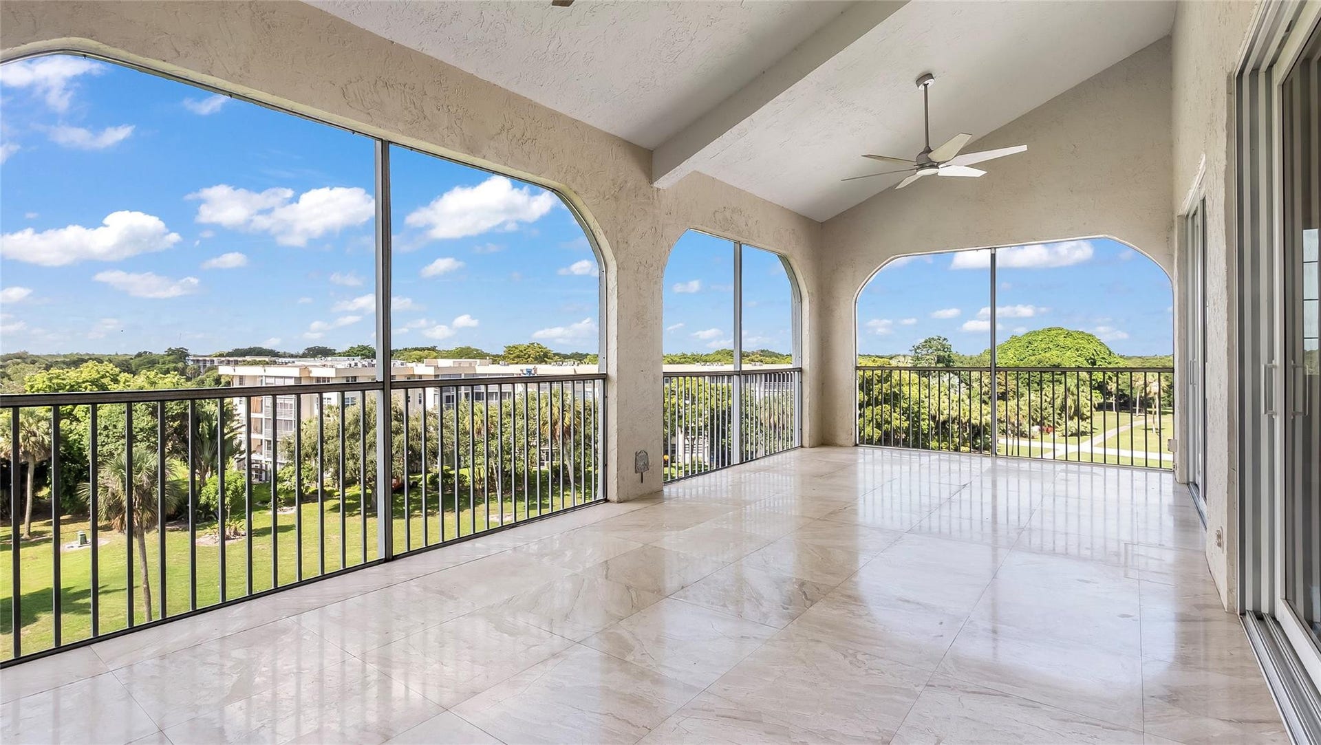 4116 W Palm Aire Drive, #166b, Pompano Beach, FL 33069 Arched openings frame sweeping views of the golf course and surrounding greenery, enhancing the serene ambiance.