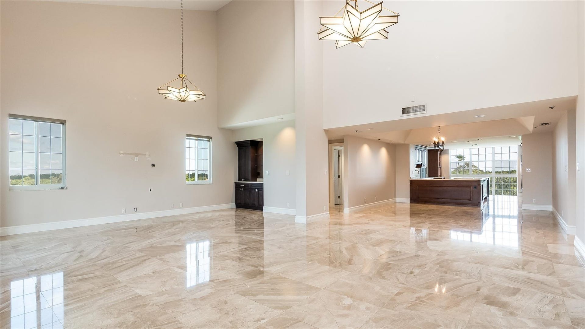 4116 W Palm Aire Drive, #166b, Pompano Beach, FL 33069 Expansive layout with large windows and sightlines into the kitchen and dining area enhances flow and natural light.