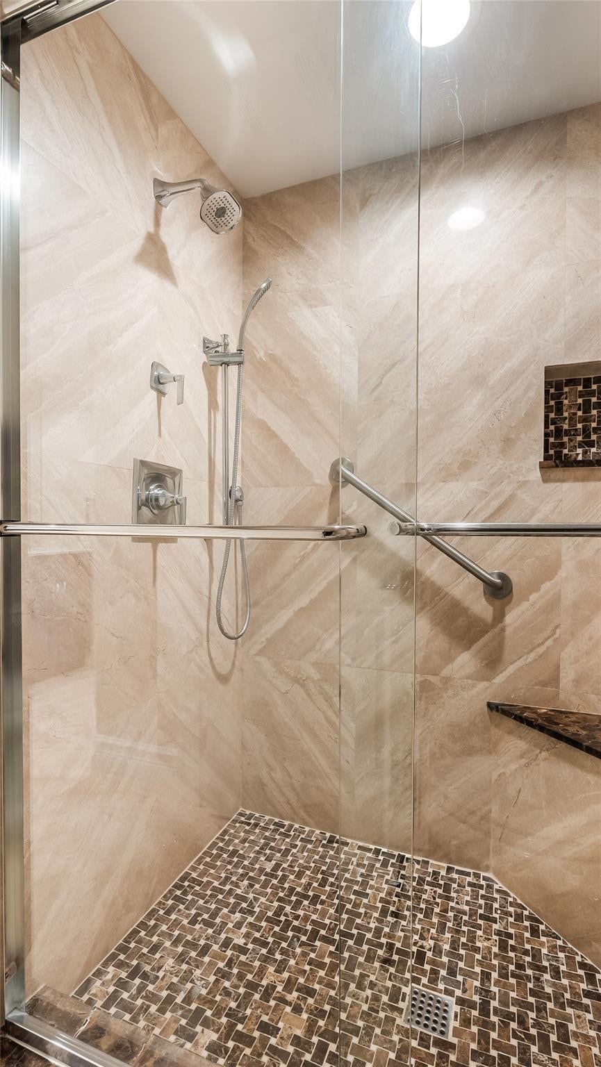 4116 W Palm Aire Drive, #166b, Pompano Beach, FL 33069 Primary Bath: Glass shower with hand-held and rainfall heads, built-in niche, and stylish tile detail create a luxurious retreat.