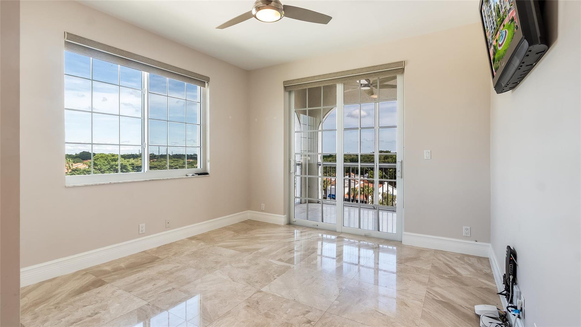 4116 W Palm Aire Drive, #166b, Pompano Beach, FL 33069 Bedroom 2: French doors open directly to the private balcony, creating an airy indoor-outdoor connection.
