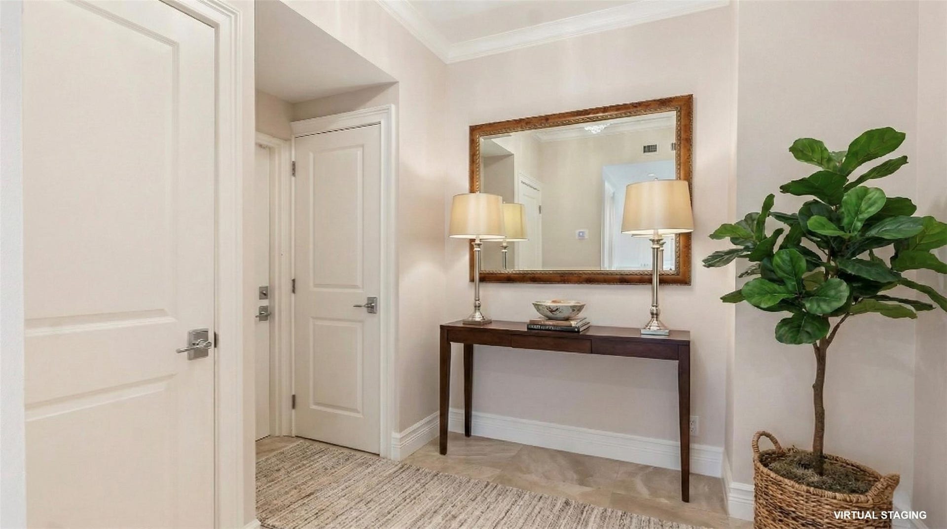 4116 W Palm Aire Drive, #166b, Pompano Beach, FL 33069 Welcoming entryway with neutral tones, crown molding, and a large wall mirror, offering a bright and elegant first impression. (Virtual Staging)