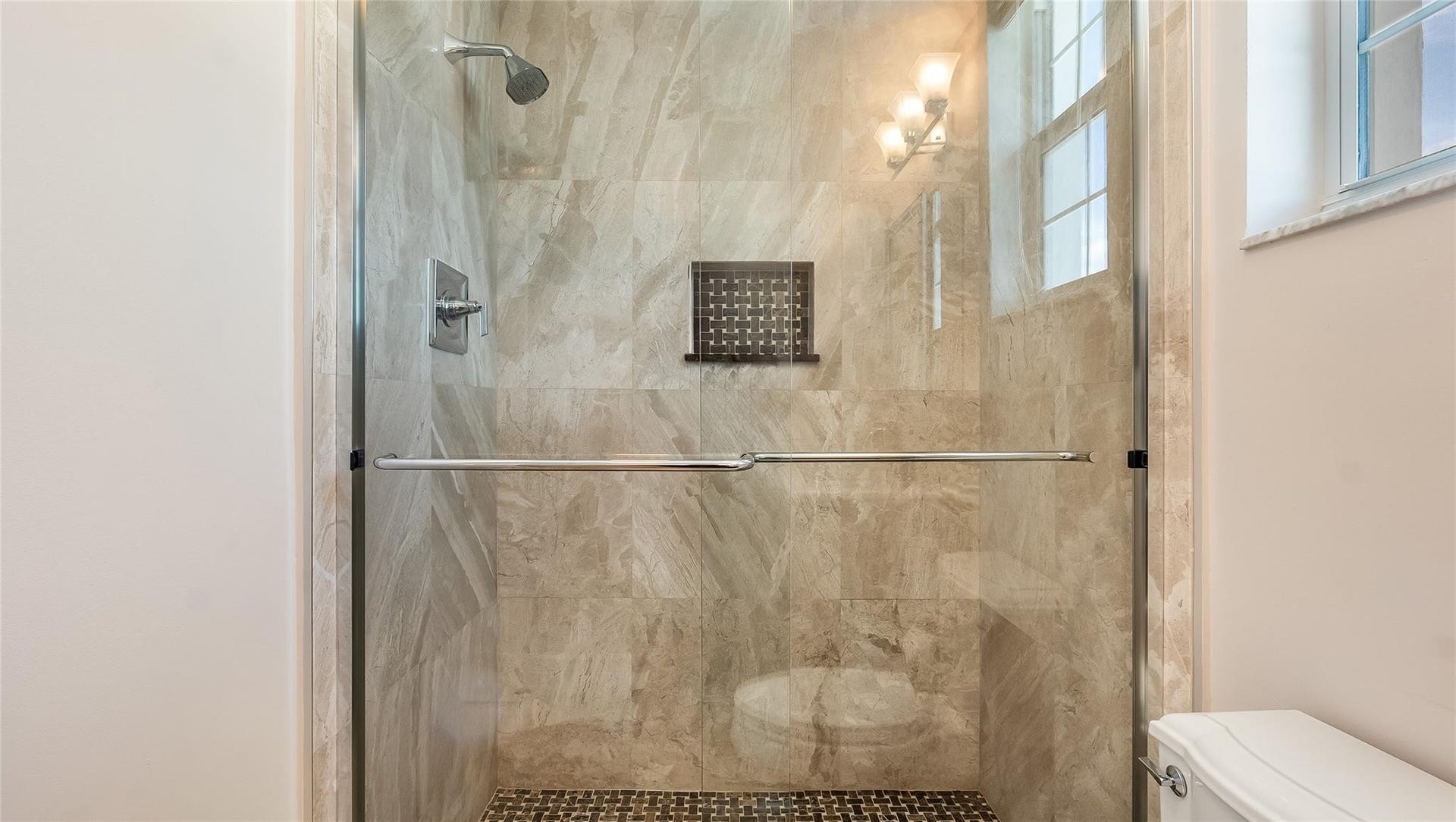 4116 W Palm Aire Drive, #166b, Pompano Beach, FL 33069 Bedroom 2 Bath: Glass shower with accent tile and window for natural light completes this stylish space.