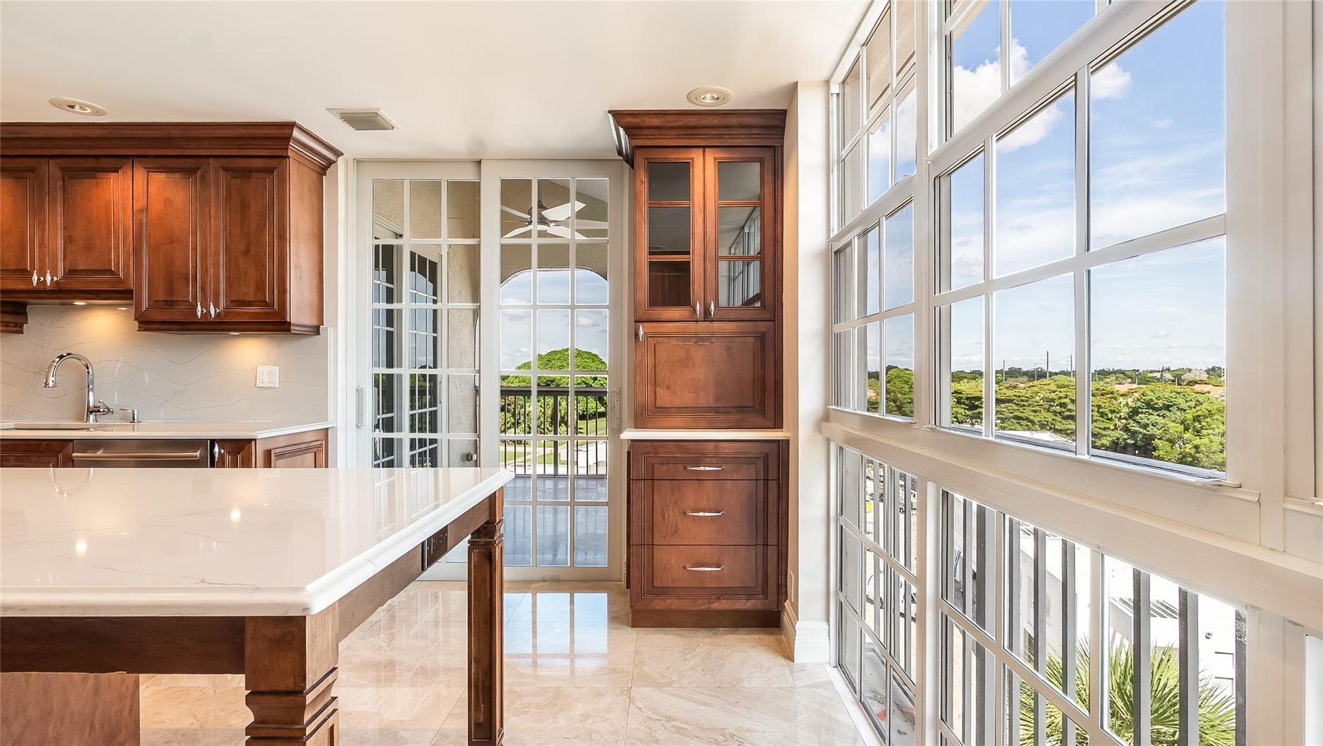 4116 W Palm Aire Drive, #166b, Pompano Beach, FL 33069 Floor-to-ceiling windows and a glass door bring in lush views and natural light, enhancing the open, airy feel.