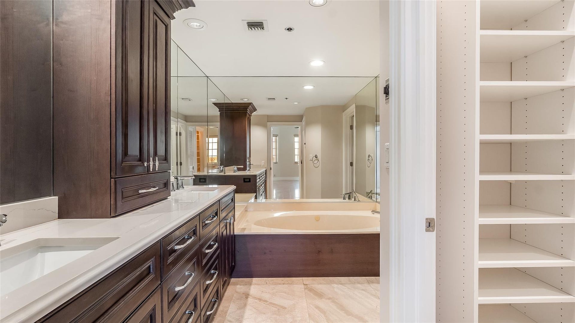 4116 W Palm Aire Drive, #166b, Pompano Beach, FL 33069 Primary Bath: Rich cabinetry offers abundant storage and timeless appeal, with soft recessed lighting enhancing the space.